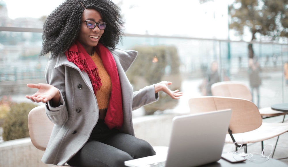 Woman hosting webinar with laptop outside